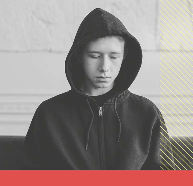 Young man looking sad while wearing a hoodie